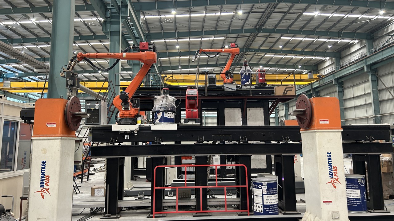 Turnkey robotic limpet coil welding cell installation with dual robots and heavy positioner