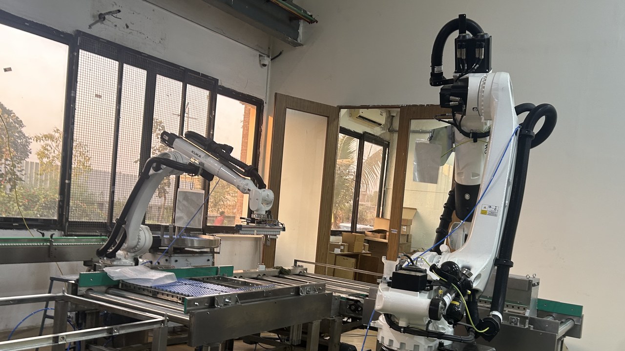Turnkey robotic pick-and-place automation cell with multi-axis robots and precision conveyor system