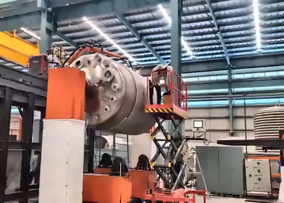 Advantage Plus limpet coil welding cell: a coil-wrapped vessel held on a positioner while the welding robot works along the coil